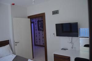 a room with a bed and a television on a wall at Grand Antalya Hotel in Antalya