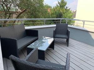 a deck with two chairs and a table and two chairs at Comfort in Bamberg