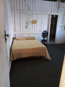 a bedroom with a large bed in a room at HOSTEL MAIANDEUA in Algodoal