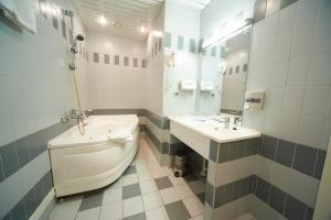 a bathroom with a toilet and a sink at Neptun Hotel in Saint Petersburg