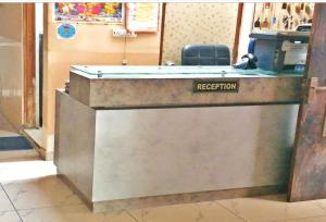 a reception desk with a registration sign on it at Hotel Raj Guest House in Jaipur