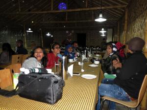 a group of people sitting at a table at Himalaya Darshan Resort in Kausani