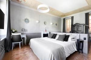 een slaapkamer met een groot wit bed en een bureau bij Hotel Cannobio in Cannobio