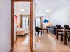 a living room with a couch and a bedroom at Toboso Apar - Turis in Nerja