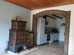 a kitchen with a fireplace and a brick wall at Haus Froehlich in Michelstadt