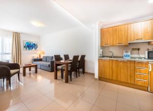 a kitchen and living room with a table and chairs at Toboso Apar - Turis in Nerja