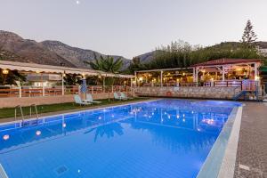 a large swimming pool in front of a hotel at Gorgona Hotel in Balíon