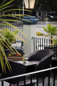a bottle of wine sitting on a table on a patio at The Bold Hotel; BW Signature Collection in Southport