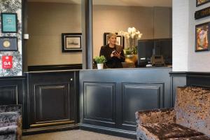 a woman sitting at a counter in a salon at The Bold Hotel; BW Signature Collection in Southport