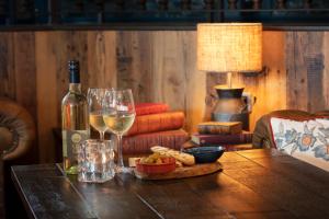 a table with a bottle of wine and a glass at The Bold Hotel; BW Signature Collection in Southport