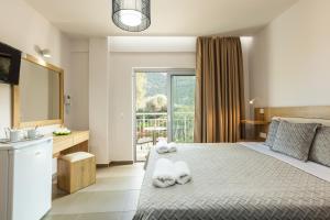 Postel nebo postele na pokoji v ubytování Gorgona Hotel