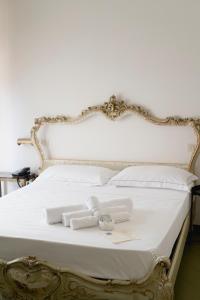 a white bed with white towels on it at Mami Sabaudia Hotel in Sabaudia