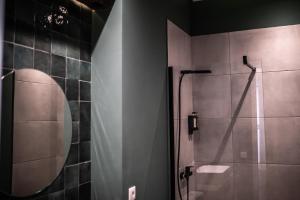 a bathroom with a shower and a mirror at Hotel sXVI - Adults Only in Telde