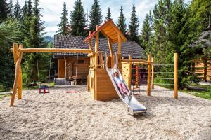 a playground with a slide and a house at Zruby Bystrá, Chopok Juh in Bystrá