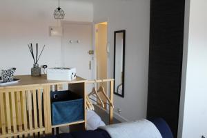 a living room with a table and a mirror at Studio hyper centre avec vue sur les Pyrénées in Saint-Jean-de-Luz
