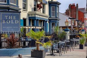 a street with tables and chairs in front of a building at The Bold Hotel; BW Signature Collection in Southport