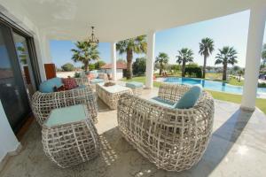 a patio with chairs and a table and a pool at ALASHATO Alacati in Alaçatı +33 photos
