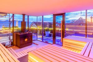 a balcony with a fireplace and a view of the city at YachtHotel Helvetia Spa- und Wellnessdomizil in Lindau