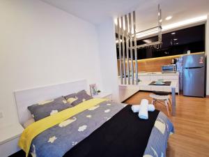 a bedroom with a bed with a stuffed animal on it at Simfoni Balakong Internet & Netflix Designer Studio in Kampong Baharu Balakong