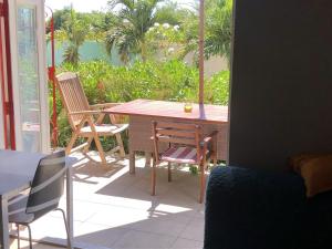 a table and chairs sitting on a patio at Advantage Apartments Curacao in Willemstad