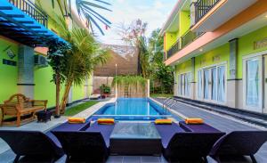 a swimming pool in the backyard of a house at Tirai Bambu Jimbaran in Jimbaran