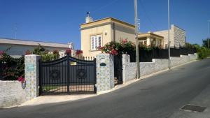 ein schwarzes Tor vor einem Haus mit Blumen in der Unterkunft Bed and Breakfast Angolo Fiorito in Civitavecchia