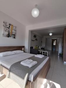 a bedroom with a large bed with towels on it at Must Stay - City Center in Larnaca