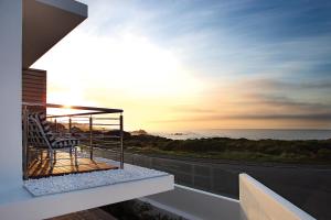 a view from a balcony of a building with a view of the ocean at One Marine Drive Boutique Hotel in Hermanus
