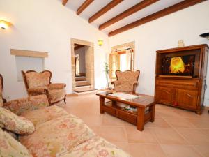a living room with a couch and a tv at House Sant Jaume in Alcudia