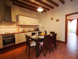 a kitchen with a table and chairs in a kitchen at Sant Vicenç, amazing house in Alcudia for 6 in Alcudia