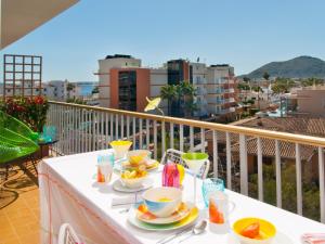 a table with plates of food on a balcony at Apartment Corales de Mar, at Alcudia Beach in Alcudia
