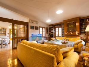 uma sala de estar com sofás amarelos e uma mesa em Villa Tramontana de Lloseta, piscina y vista montaña em Lloseta