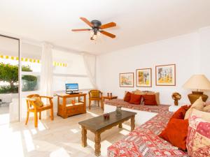 a living room with a couch and a table at Apartment Oiza Sand Castles 23 at Alcudia Beach, WIFI and aircon in Alcudia