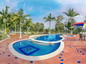 uma piscina com água azul num resort em Finca Hotel San Isidro em Hojas Anchas