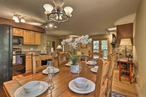 a kitchen and dining room with a wooden table and chairs at Cozy Condo on Vasquez Creek with Free Shuttle Access in Winter Park