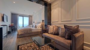 a living room with a bed and a couch at Vivid Blue Serenity Resort in Sveti Stefan