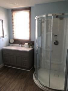 a bathroom with a shower and a sink at Boathouse Country Inn in Rockport