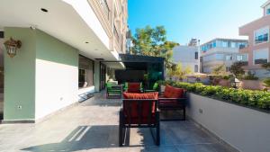a patio with chairs and a table on a balcony at The Mori Club Hotel in Antalya