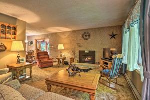 a living room with a couch and a fireplace at Poconos Home with Fire Pit, Walk to Locust Lake! in Pocono Lake