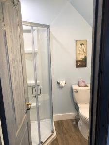 a bathroom with a shower and a toilet at Boathouse Country Inn in Rockport