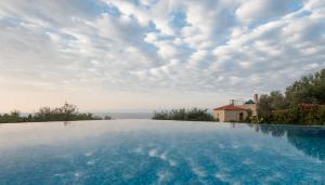 a swimming pool with a view of the sky at Alonissos Poikilma Villas exclusive luxury villas in nature with private pools in Alonnisos