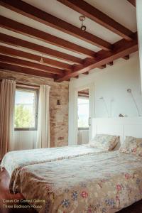 a bedroom with two beds and two windows at Casas Do Consul - Mar y Montaña in O Vicedo