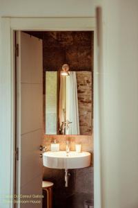 a bathroom with a sink and a mirror at Casas Do Consul - Mar y Montaña in O Vicedo