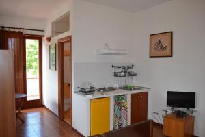 a kitchen with a yellow and white counter top at Agriturismo Le Forre del Treja (La Villa) in Civita Castellana