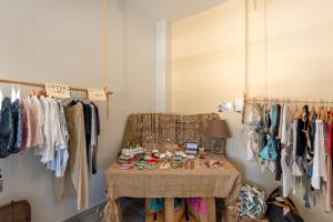 a dressing room with a table and clothes racks at Parosland Hotel in Aliki