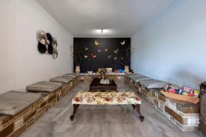 a room with couches and a table in a room at Parosland Hotel in Aliki