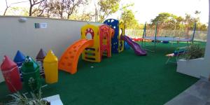 a play area with a playground with a slide at Park Veredas- Rio Quente Temporada in Rio Quente