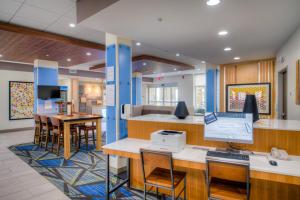 an office with a desk with a laptop on it at Holiday Inn Express & Suites - Remington, an IHG Hotel in Remington