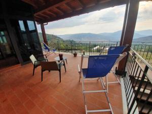 Un balcón con sillas y una mesa con vistas. en Resort San Nicola - Restaurant and Wellness Fitness, en Polizzi Generosa