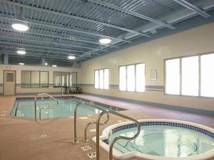 a large swimming pool in a large building at Glenwood Inn & Suites in Trail